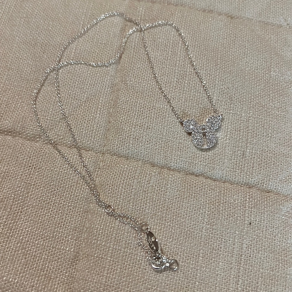 Silver necklace with “J” cutout of Mickey head